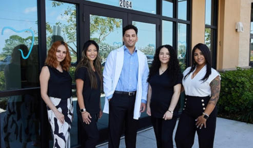cape coral team in front of the office building